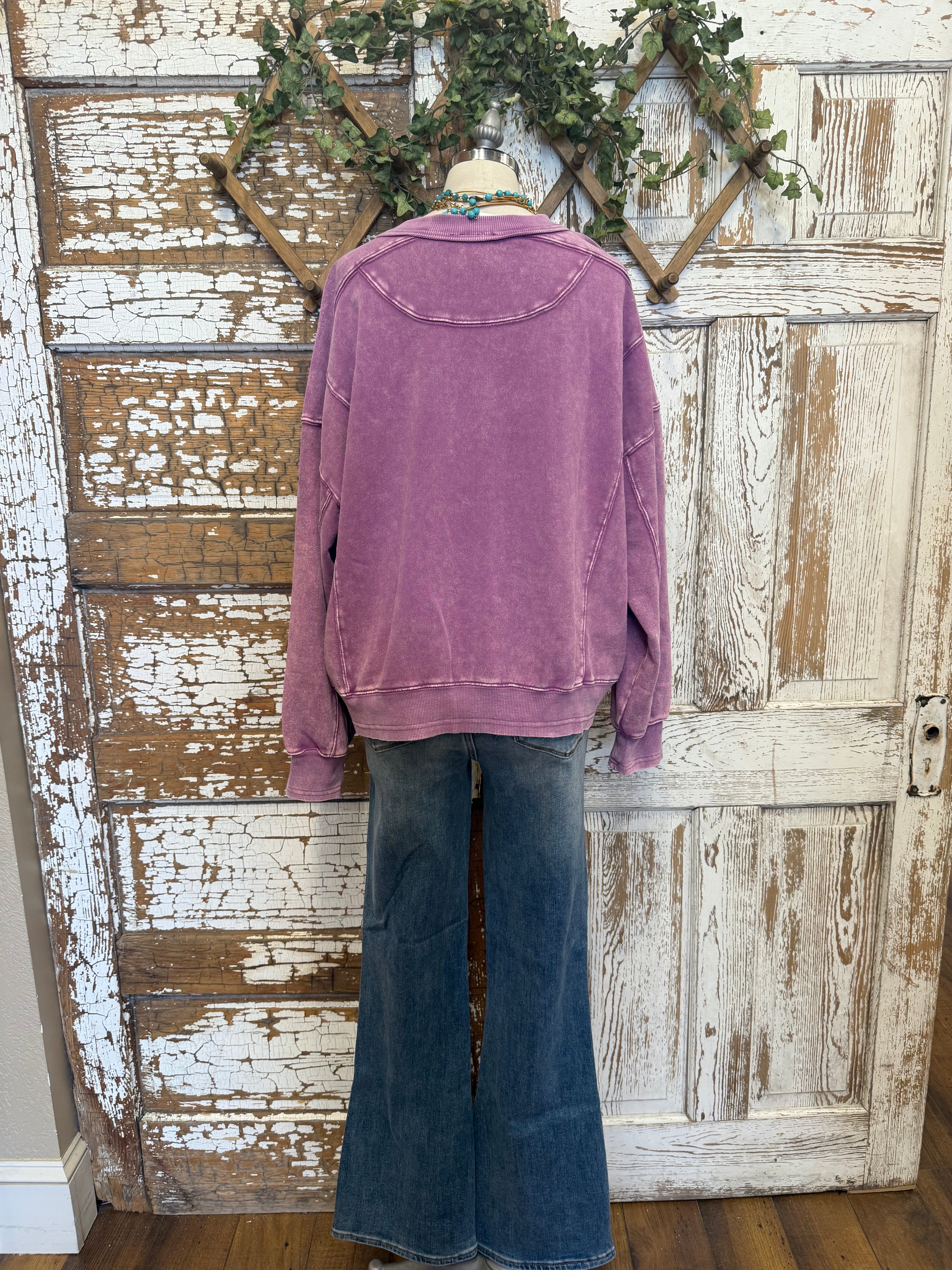 Mannequin wearing a purple sweatshirt and blue jeans and handmade jewelry in Springfield, MO boutique