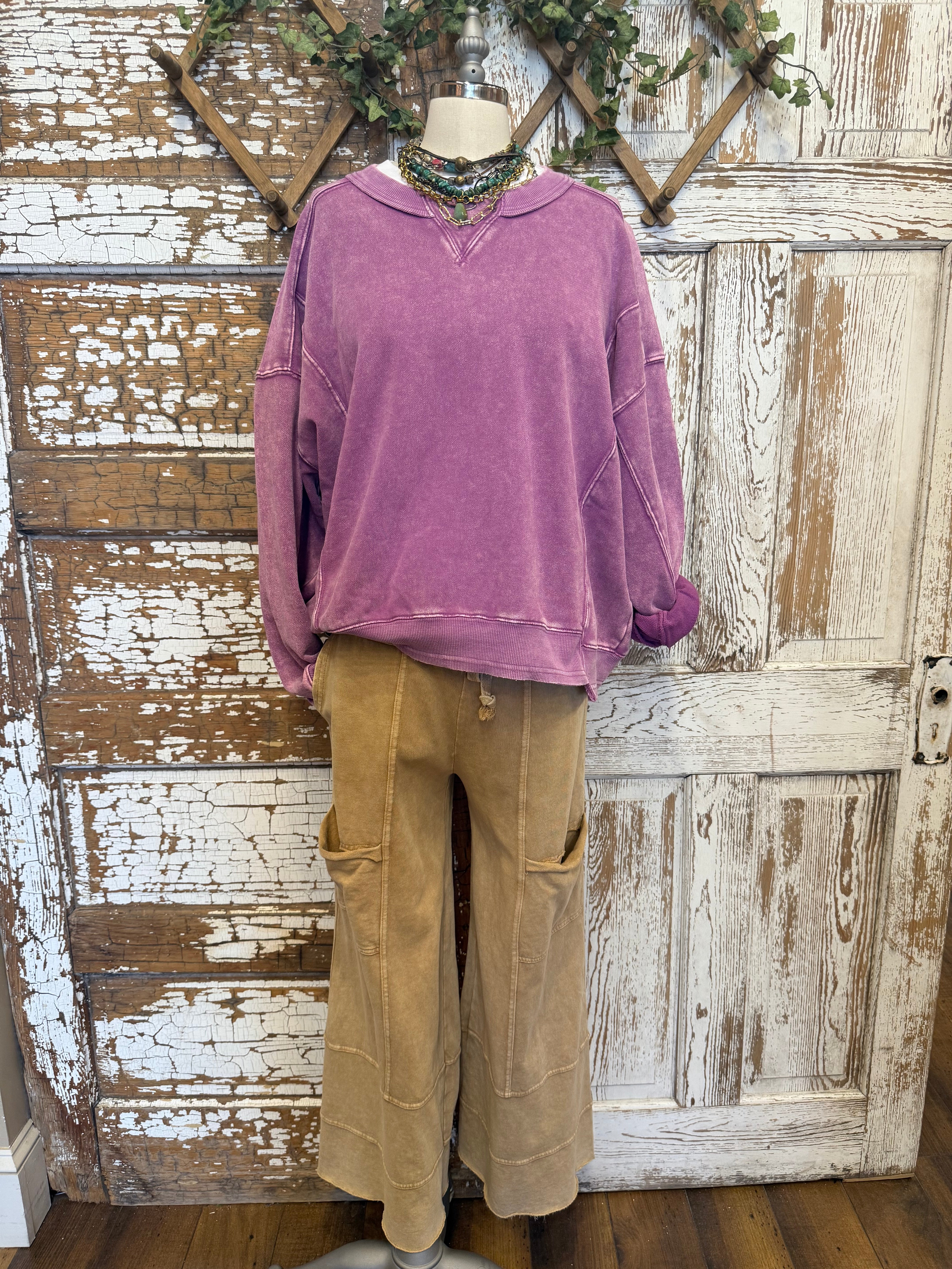 Mannequin wearing a purple sweatshirt and loungewear pants and handmade jewelry in Springfield, MO boutique