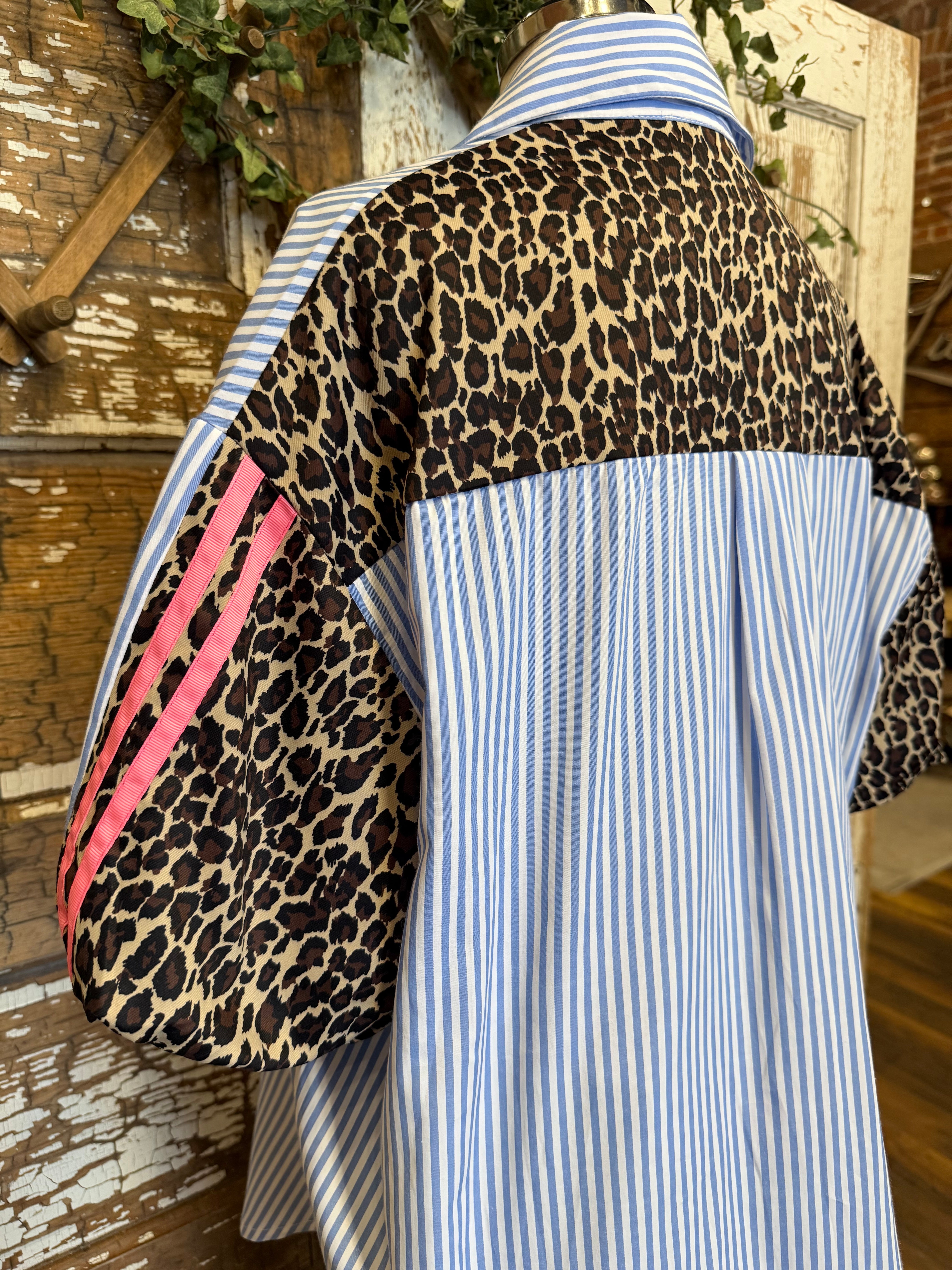 Mannequin wearing a blue striped shirt with pink and leopard detail and dark jeans in Springfield, MO boutique