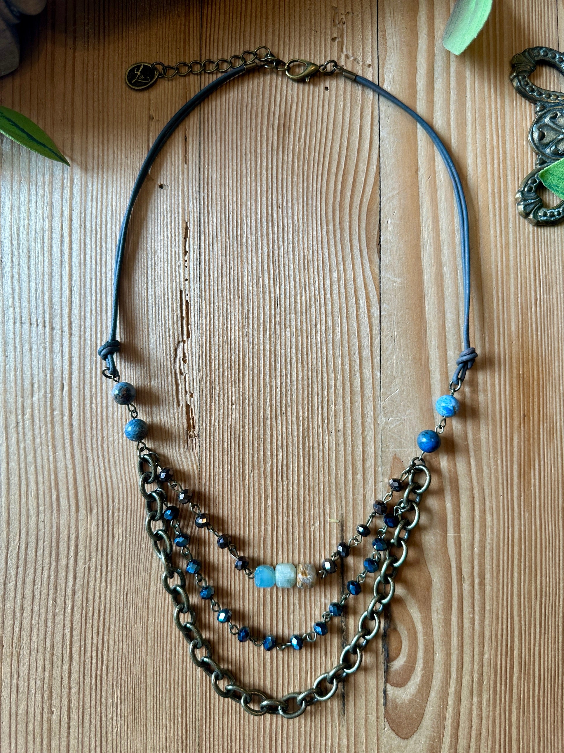 Layered brass chain necklace with blue stone and crystal beads