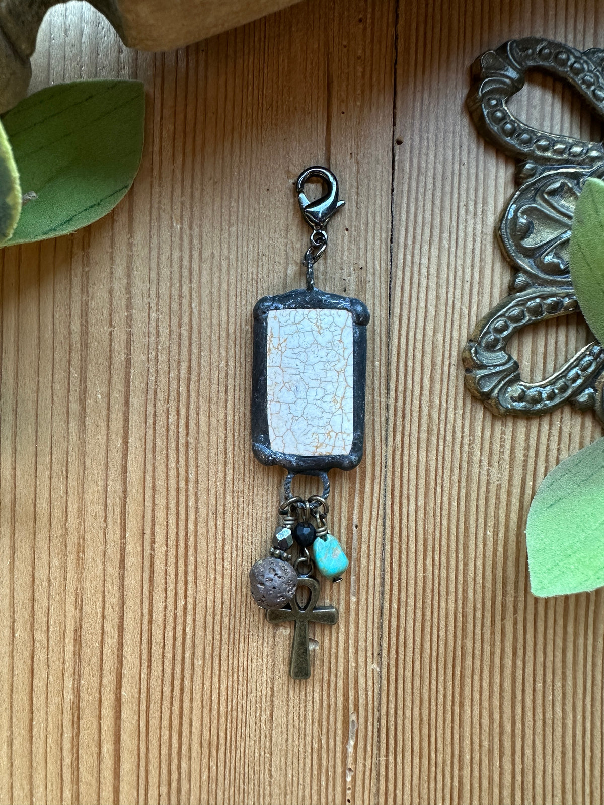 Sacred Ground Ankh Crackle Stone Pendant Charm with white crackle stone in a soldered frame, brass ankh, lava stone, turquoise, and pyrite dangles on a lobster clasp