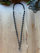 Midnight Black Interchangeable Necklace with matte black beads, antique brass links, suede cord, and charm drops