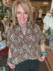 Lu wearing leopard print blouse and turquoise jewelry in Leavenworth, KS boutique